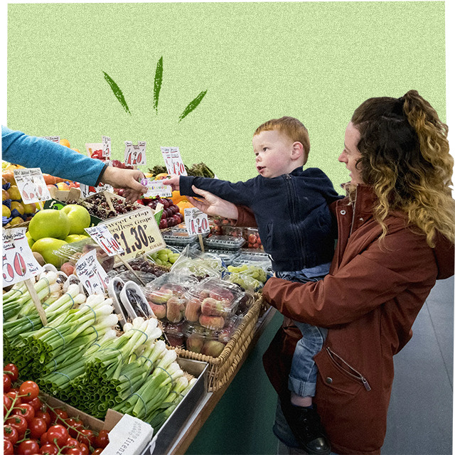 a child and mother selecting fruit and veg